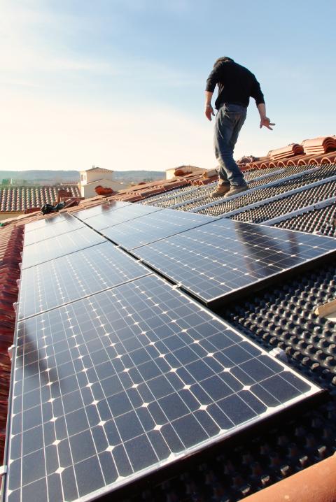 Ouvrier posant des panneaux solaires