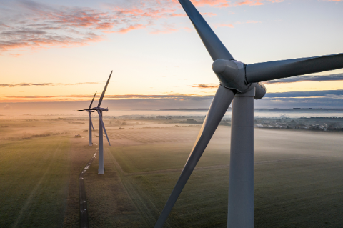 Three wind turbines at sunrise