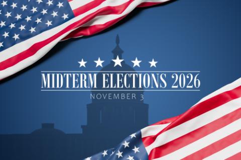 The wrinkled flag of the USA draped onto a blue surface with capitol silhouette and the text "Midterm Elections 2026 - November 3". Web banner