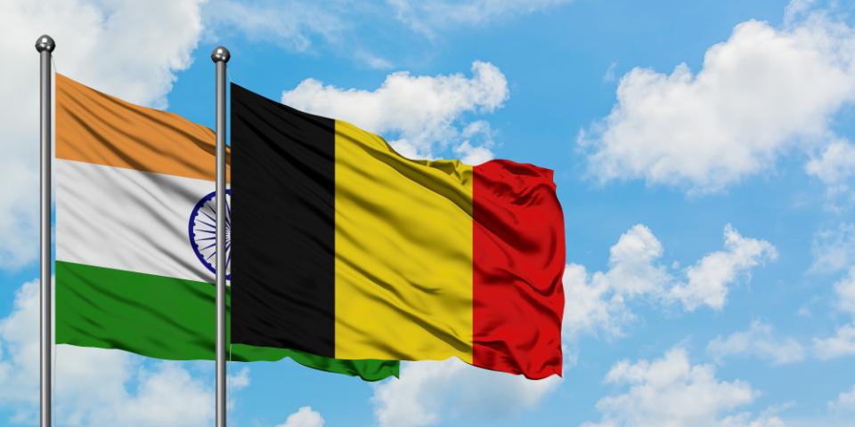 India and Belgium flag waving in the wind against white cloudy blue sky together. Diplomacy concept, international relations.