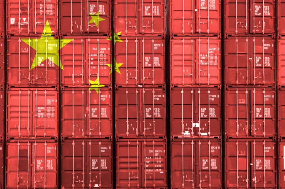 China Flag over Stack of Containers at a Port