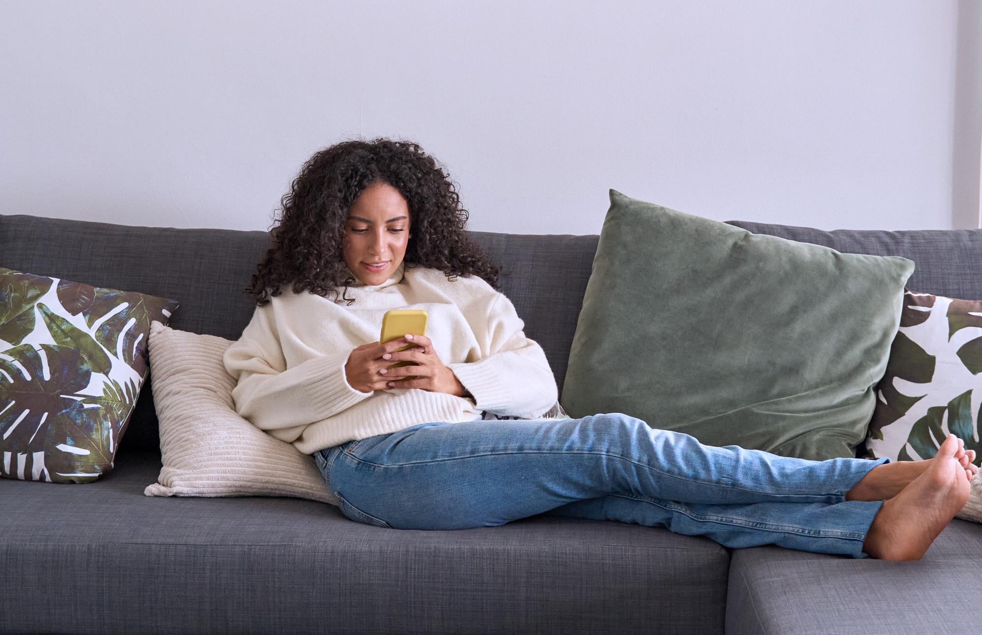 A seated woman looking at tax-efficient savings solutions on a laptop