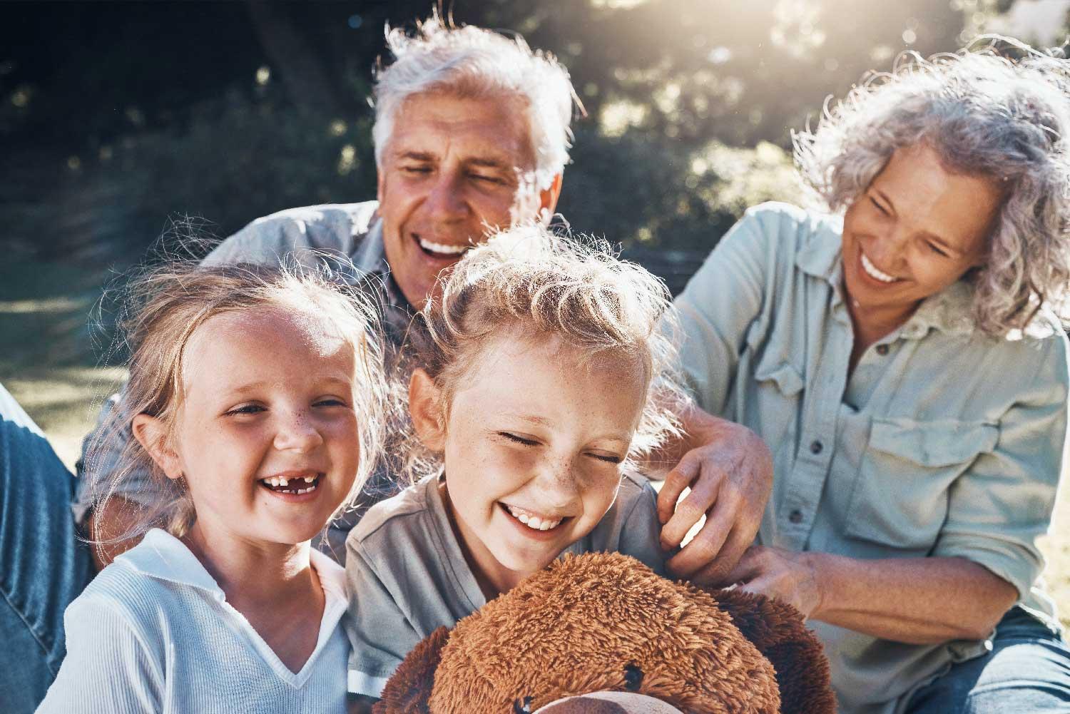 Family, children and love with a girl, grandparents and sister outdoor in a nature park for fun and adventure. Kids, park and picnic with an elderly male, female and grandchildren laughing outside