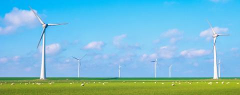 Windmill park in the ocean, drone aerial view of windmill turbines generating green energy